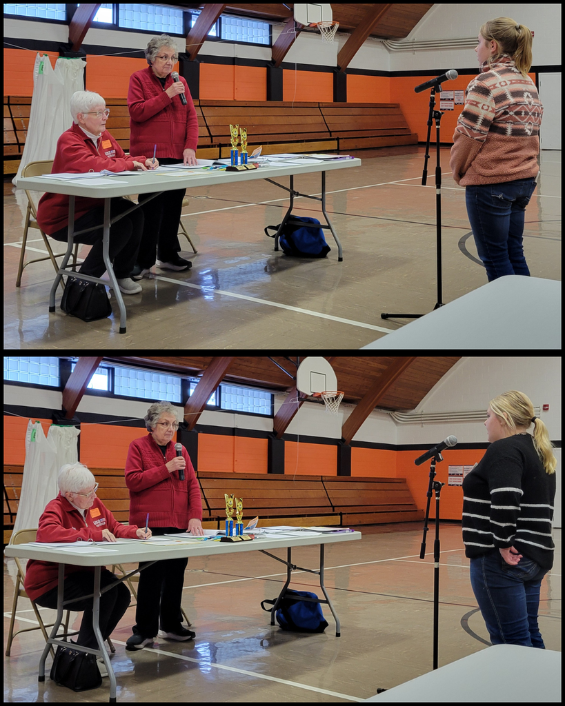 Junior high students speaking into a microphone in front of two women at a table