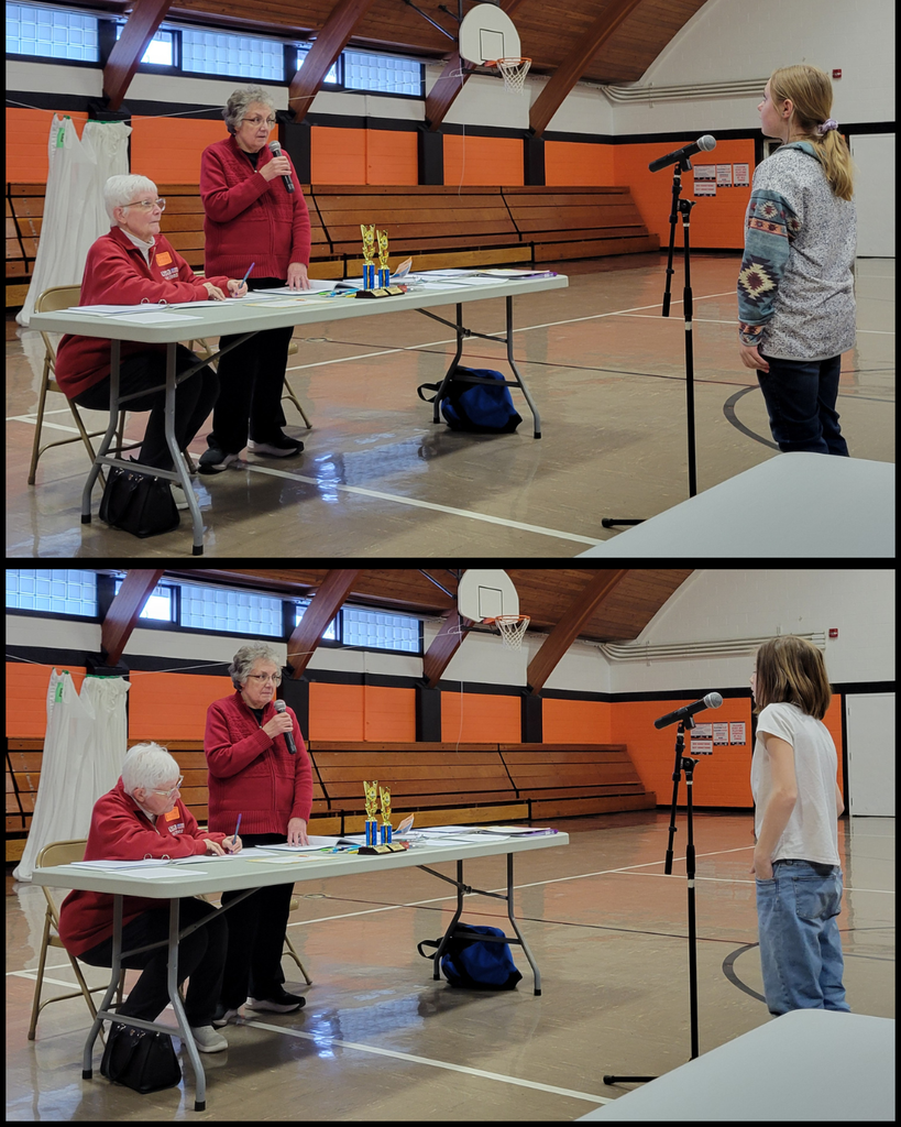Junior high students speaking into a microphone in front of two women at a table