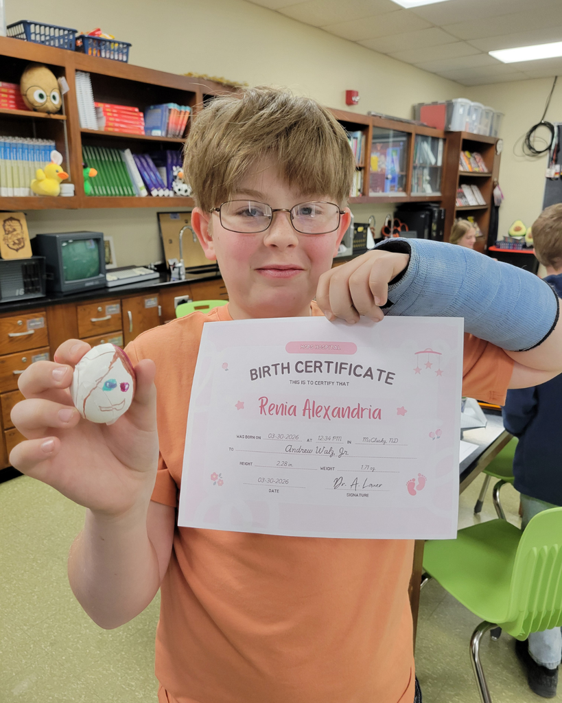A junior high student holding an egg and a birth certificate