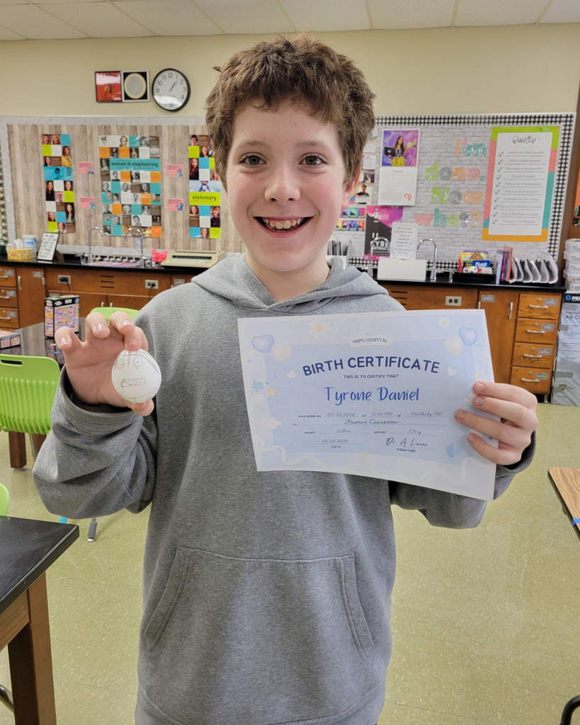 A junior high student holding an egg and a birth certificate