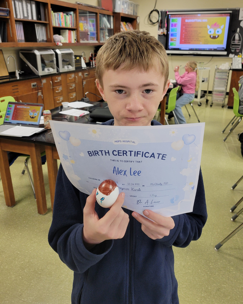 A junior high student holding an egg and a birth certificate
