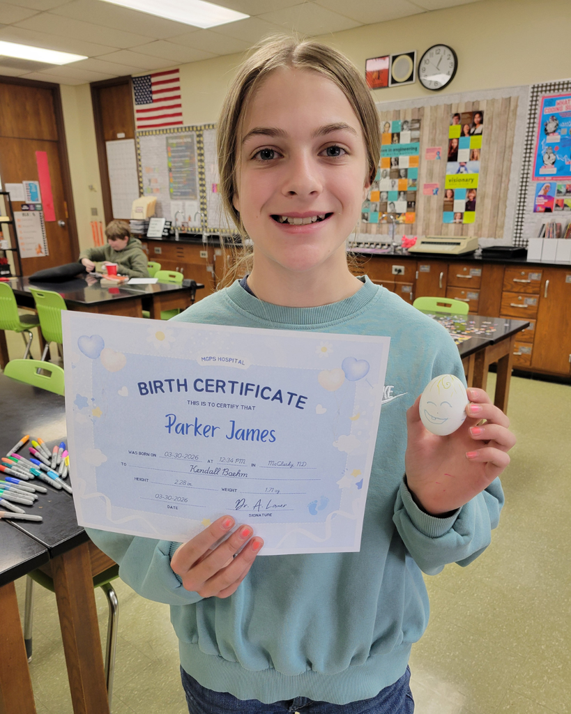 A junior high student holding an egg and a birth certificate