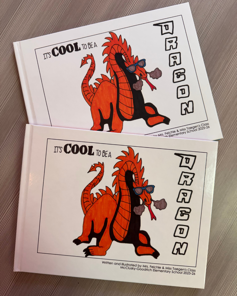 Two copies of the "It's Cool to be a DRAGON" book. A white hardcover book with an orange dragon on the cover.