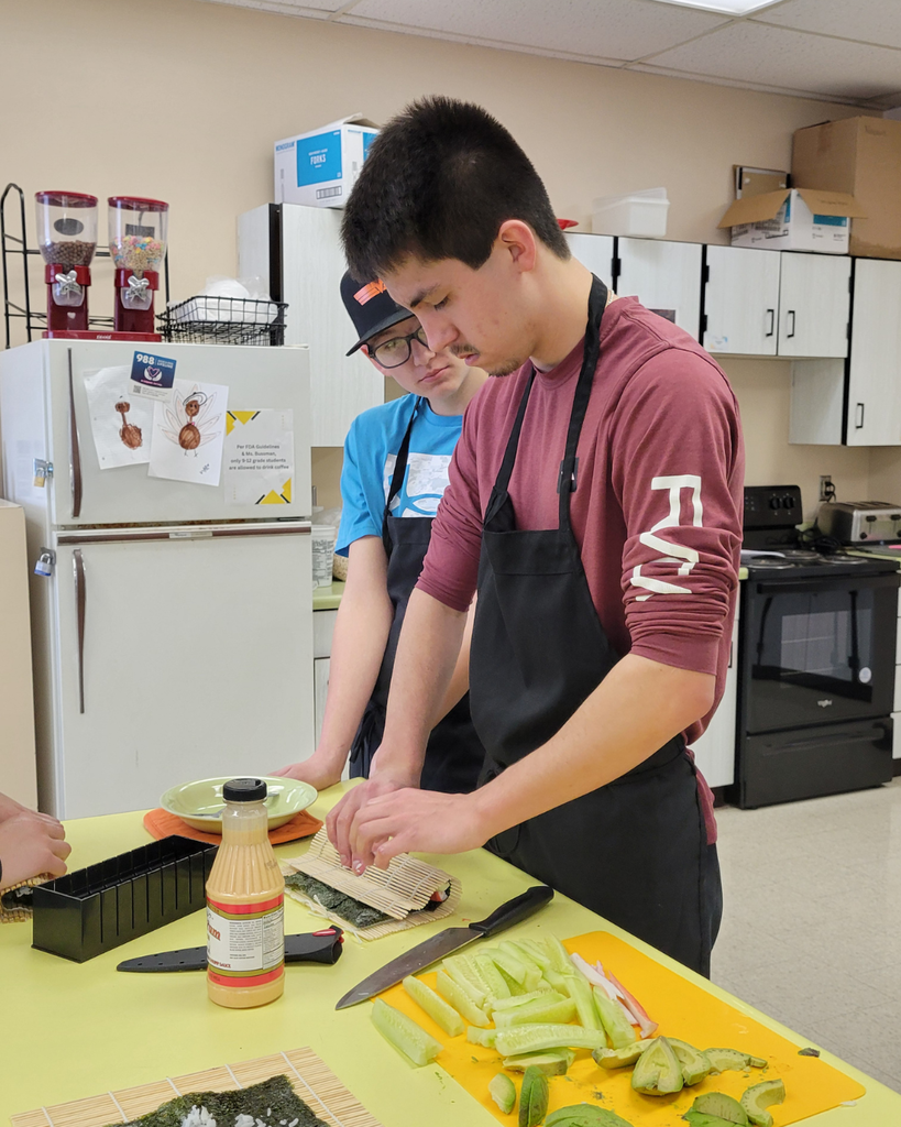 A high school student making sushi in a kitchen setting