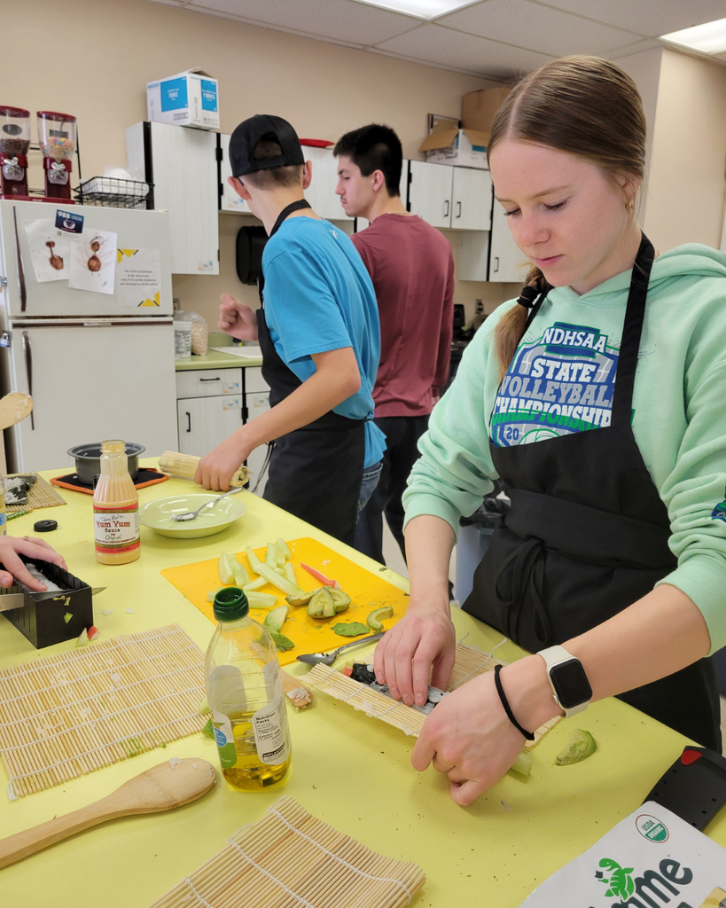 A high school student making sushi in a kitchen setting