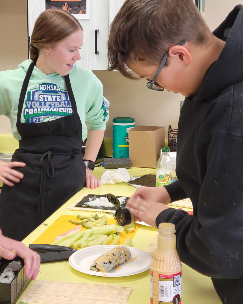 A high school student making sushi in a kitchen setting