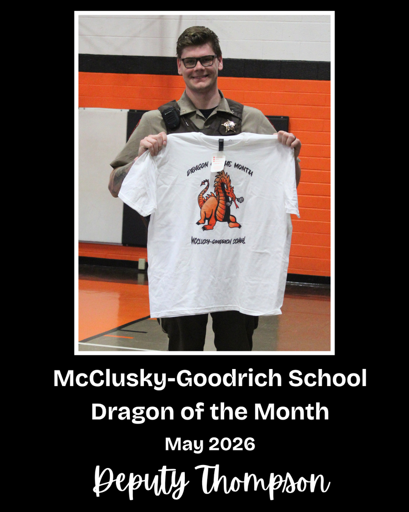 A sheriff's deputy holding a Dragon of the Month t-shirt