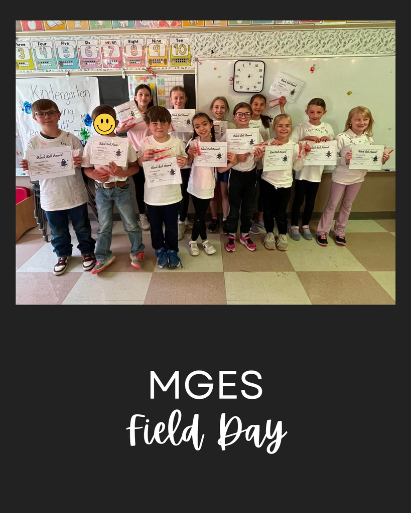 Photo of elementary students standing in a classroom holding certificates