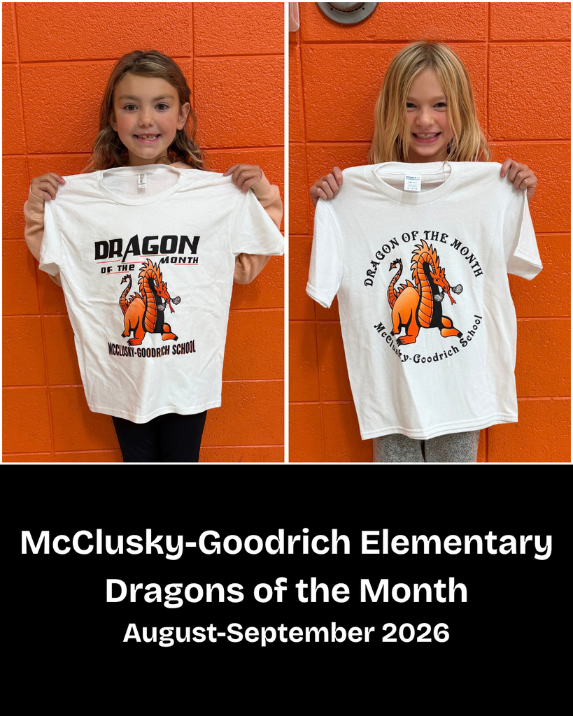 Two elementary students posing with Dragon of the Month t-shirts