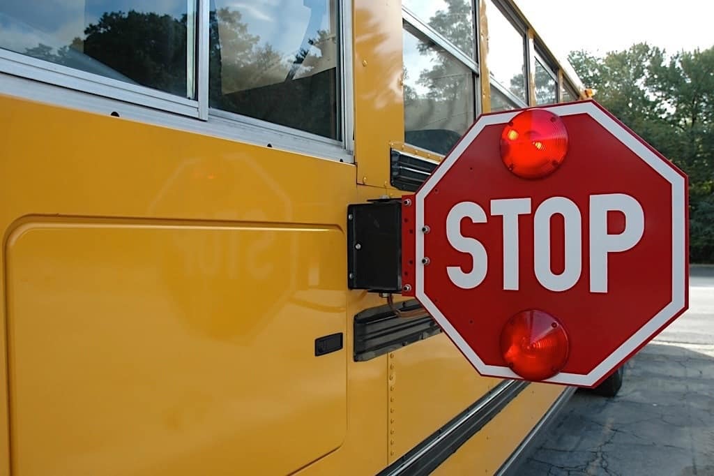 Activated STOP arm on a school bus
