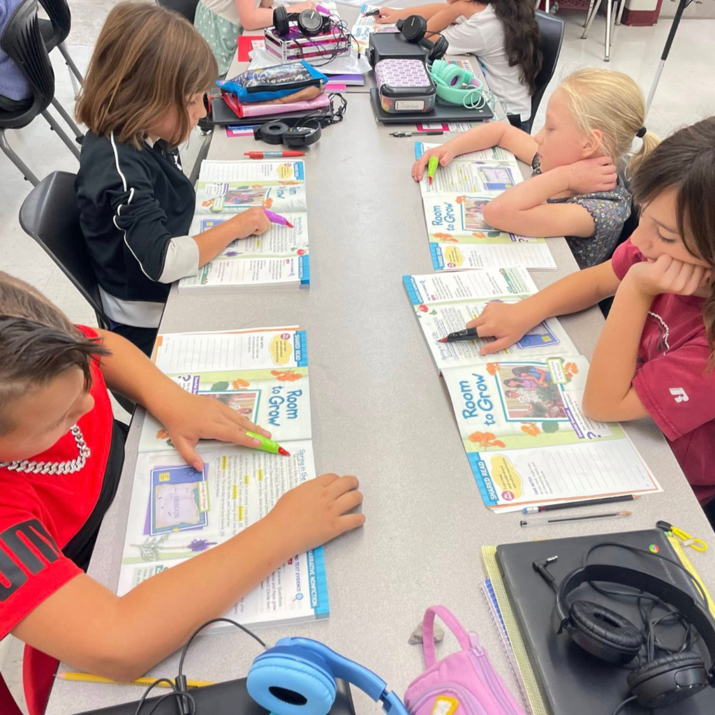 Kids reading books with monster fingers