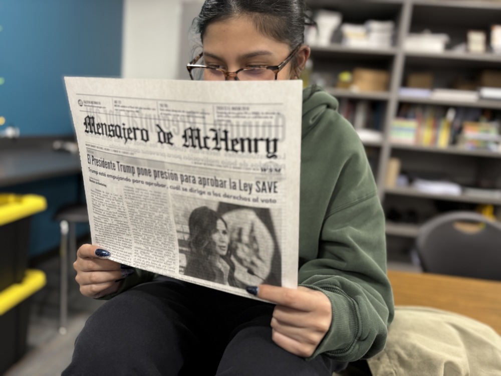 MCHS senior Aike Villa reads a Spanish version of the McHenry Messenger