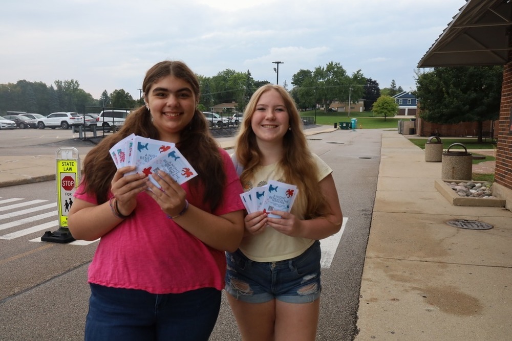 Two students with FC student council promote Homecoming Week for Tuesday Takeover