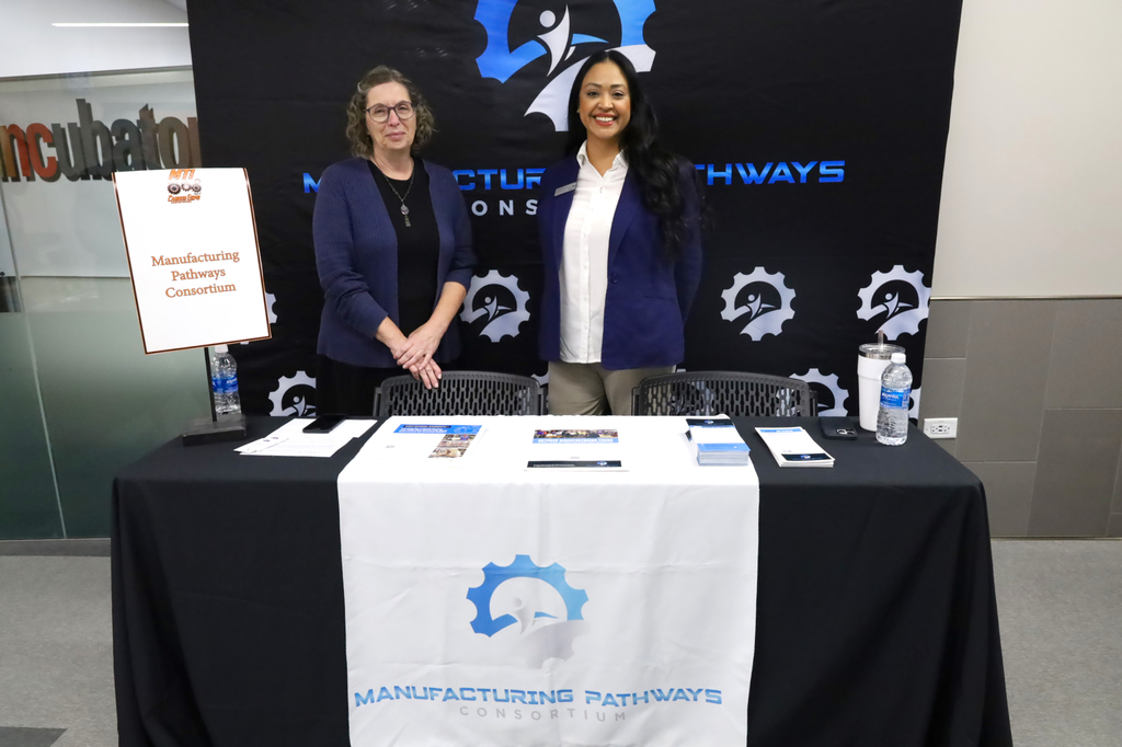 Two people at Manufacturing Pathways Consortium booth