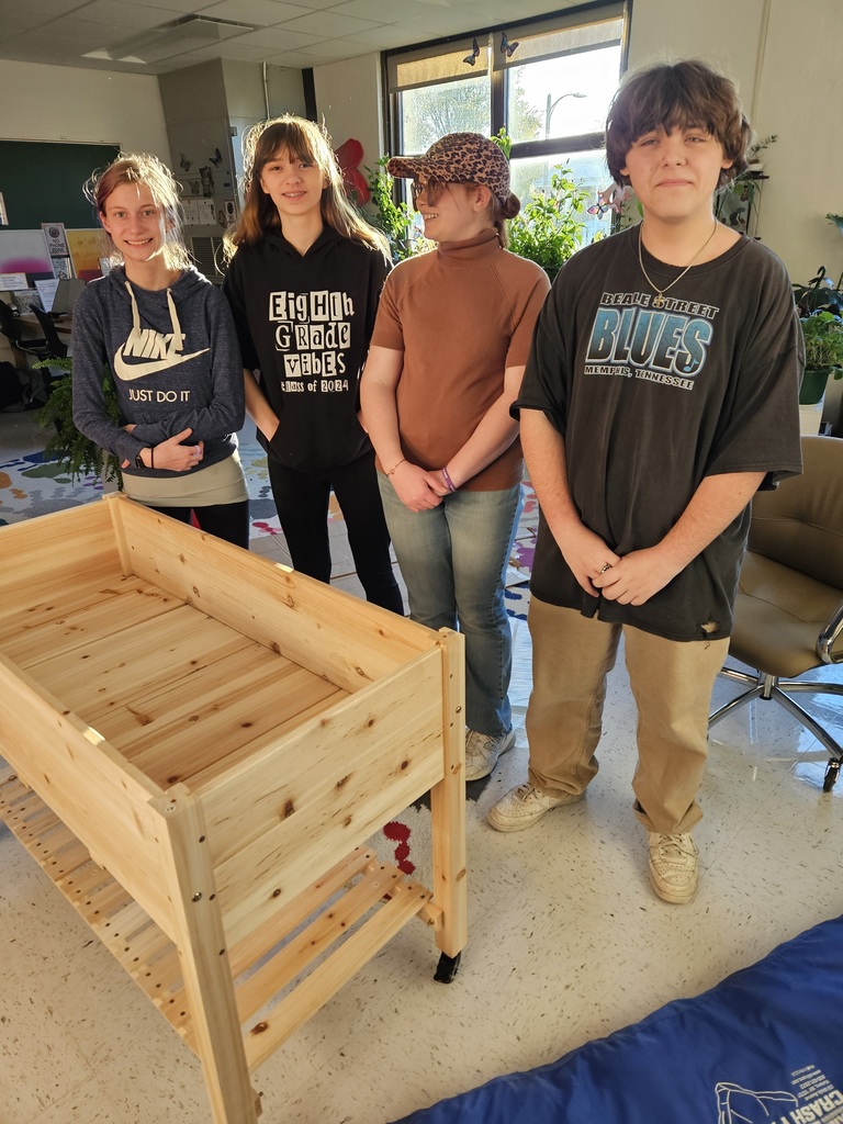 Four students next to planter