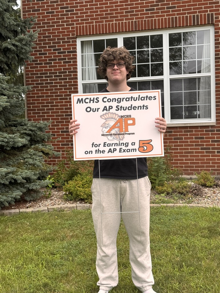 Student with AP 5 sign: MCHS Congratulates our AP  for earning a 5 on the AP exam