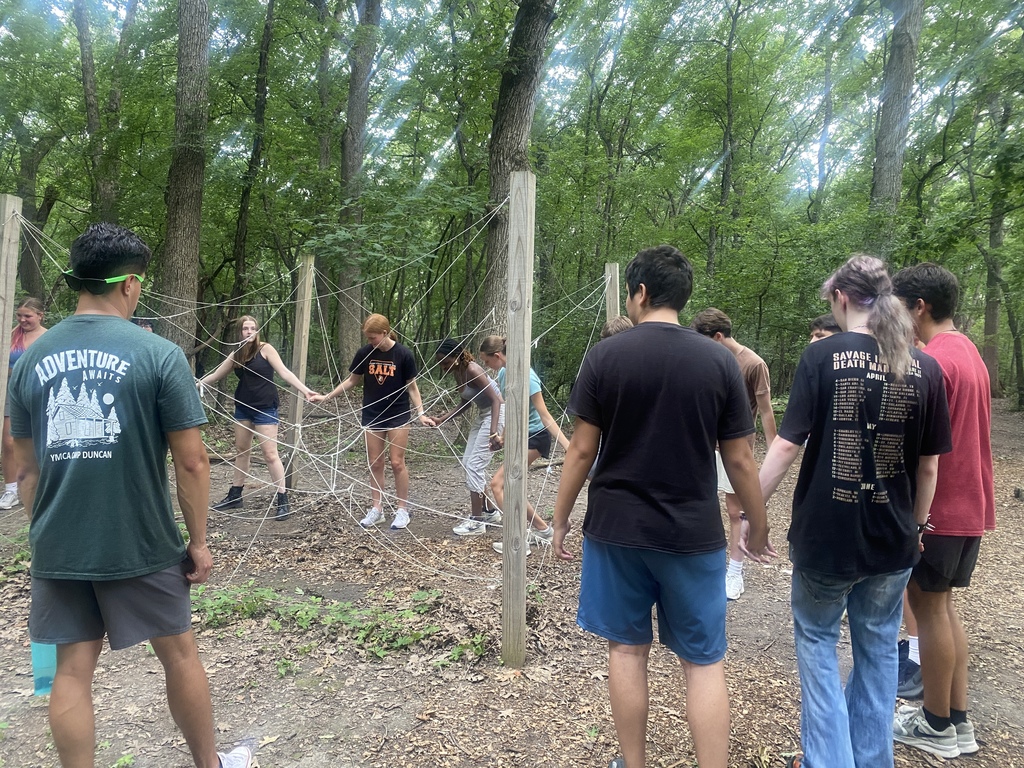 Students holding hands for a ropes course 