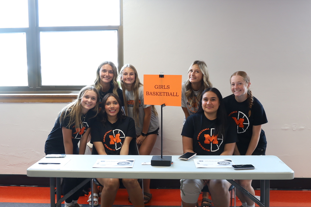 Seven girls basketball students at a Girls Basketball table. 
