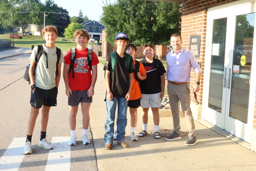 Principal and group of students smiling 