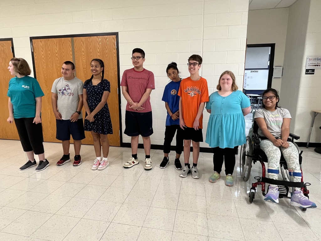 Students standing and smiling 