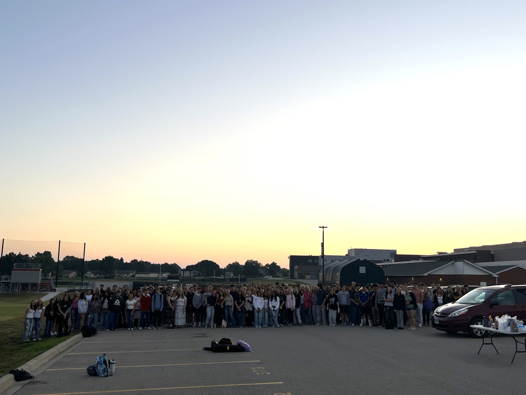 Students standing in the parking lot by the sunrise