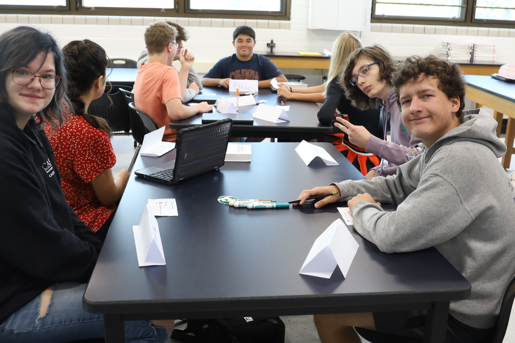 Students at a lab table smiling for the camera 