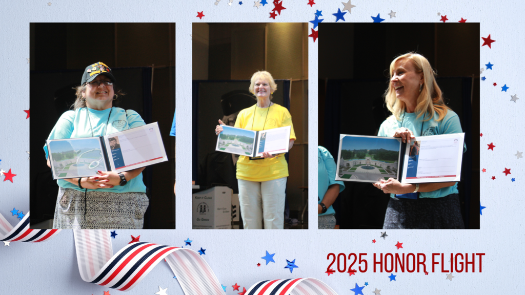 Three veterans holding books with photos in them