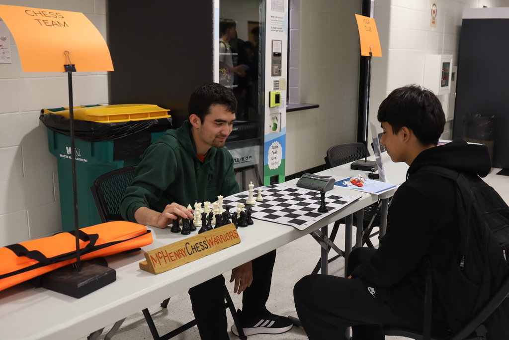 Two students playing chess with McHenry Chess Warriors