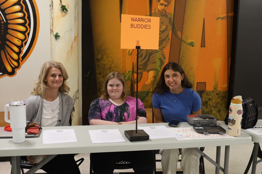 Two teacher and a student at Warrior Buddies booth