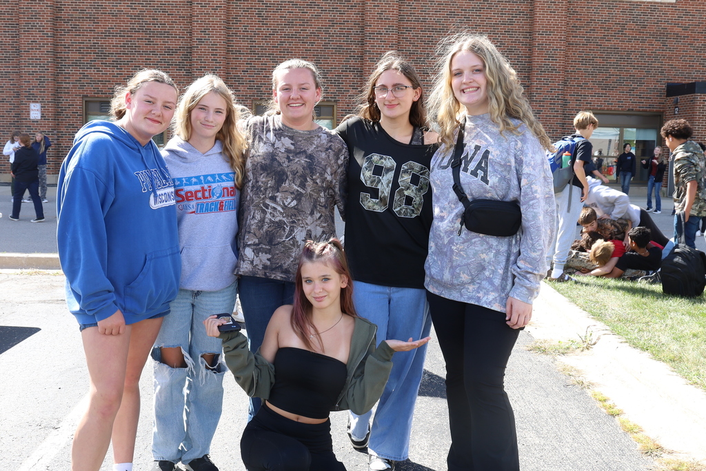 Students posing some wearing camo 