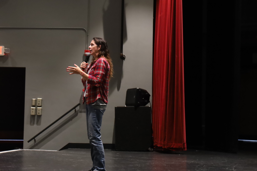 Midny McGinnis speaking on stage