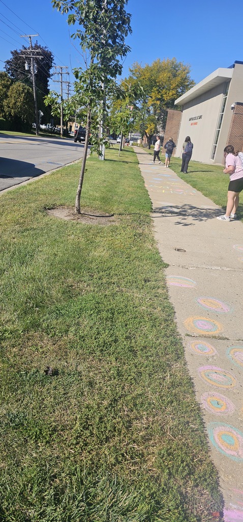 Students drawing on the sidewalk