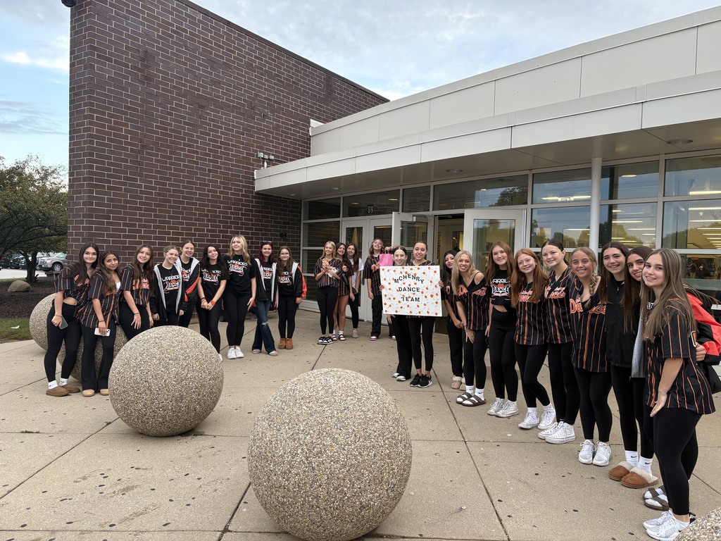 Dance team in the front of the school with Welcome MCHS Team sign