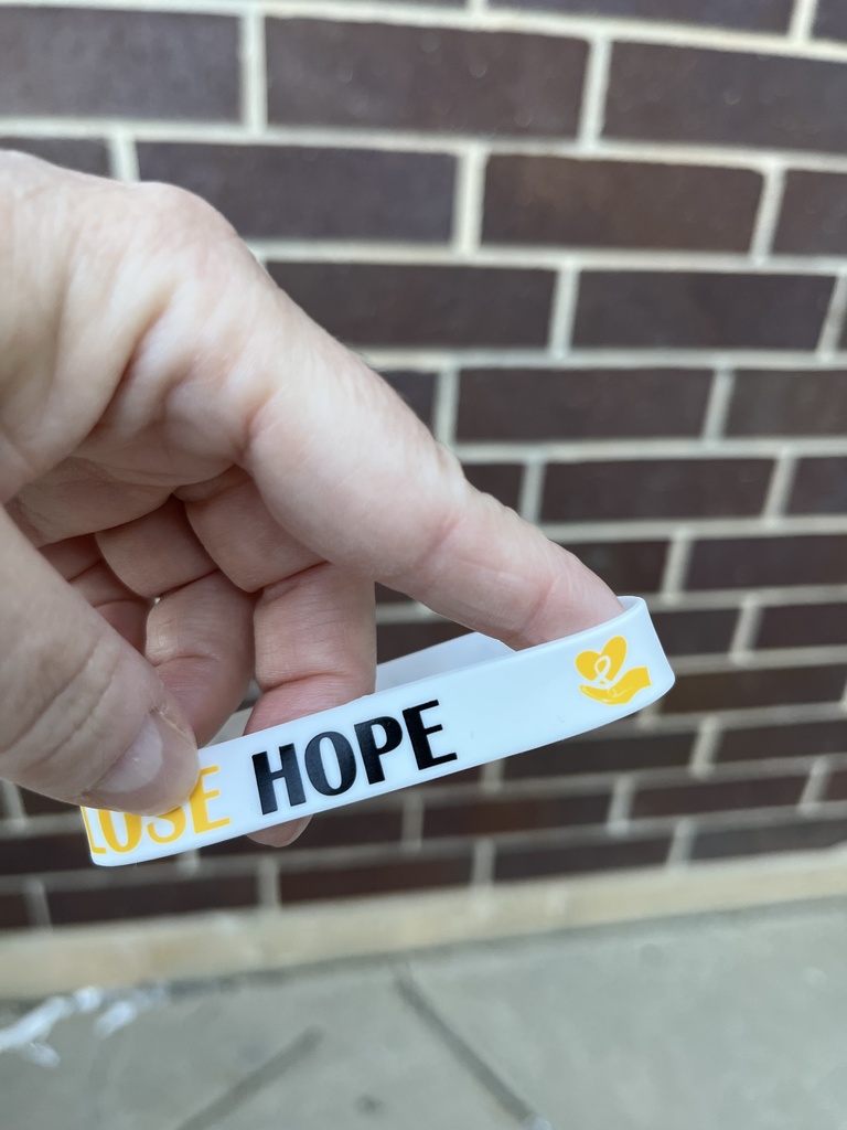 Bracelet that says Hope with childhood cancer symbol