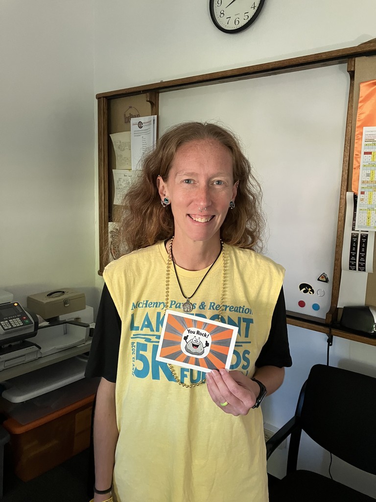 Sasha holding "You rock!" postcard with a rock cartoon