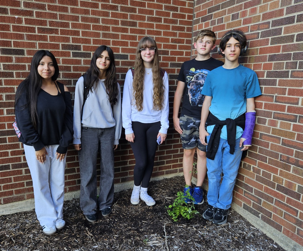 Five students standing outside