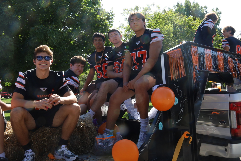 Football students sitting on a float