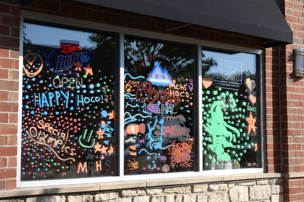 Windows painted with Special Olympics Happy Hoco and different art related to under the sea