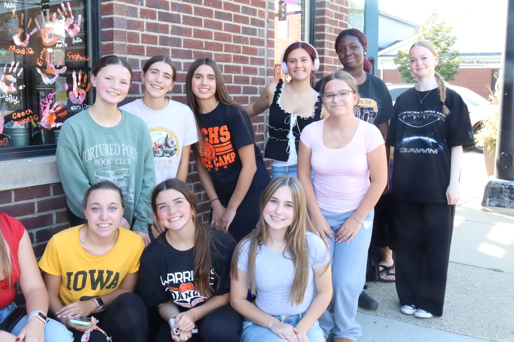 Group of students in front of windows 