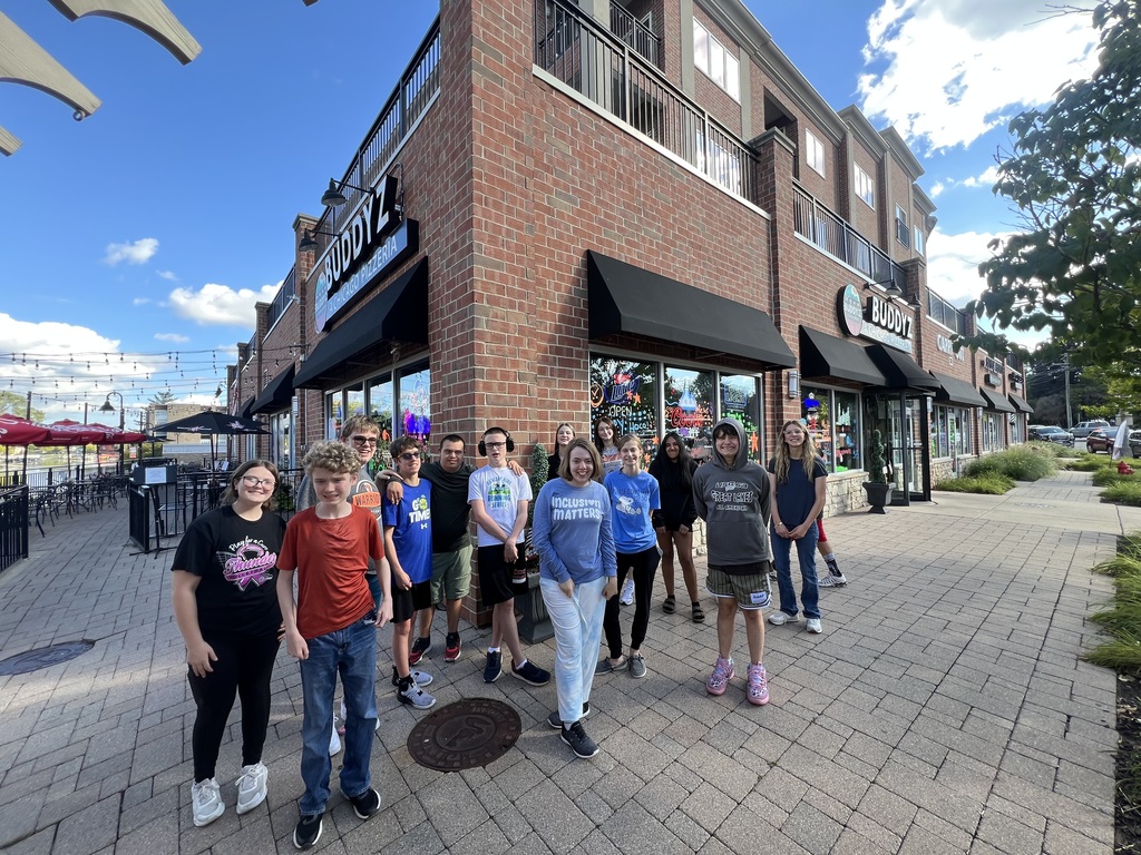 Group of students standing in front of a building
