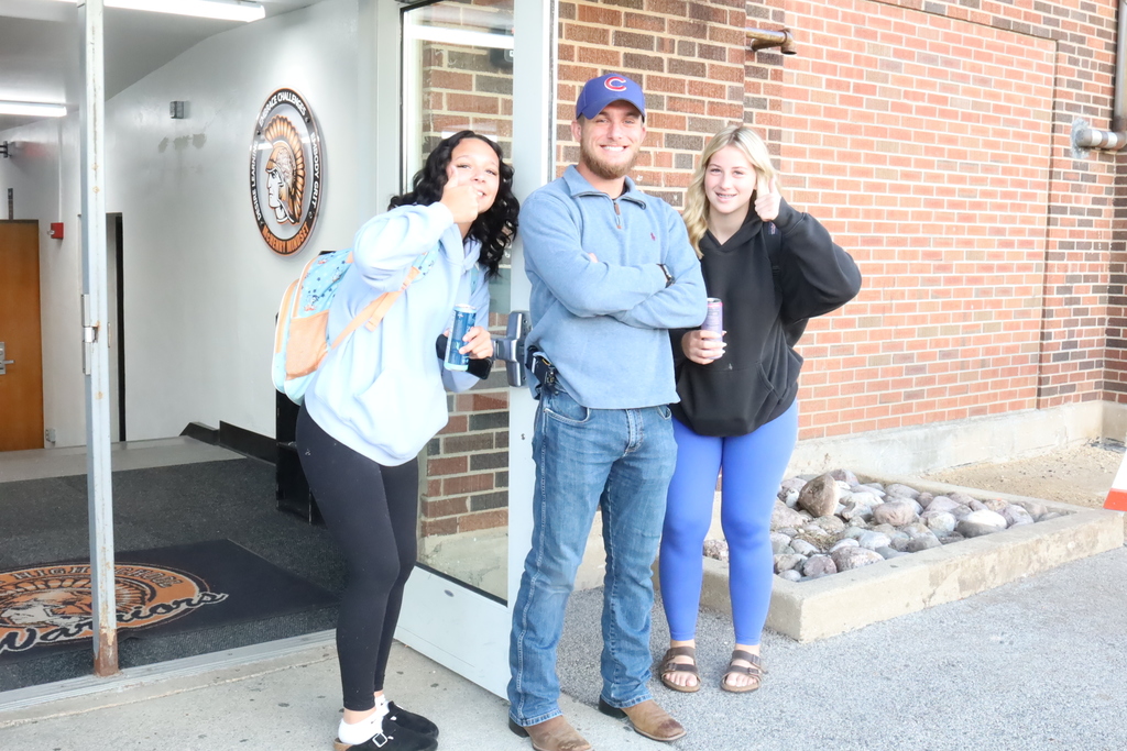 Three students and a staff member in blue