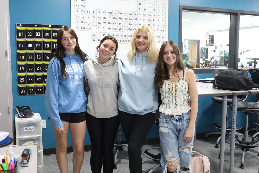 Four students in blue 