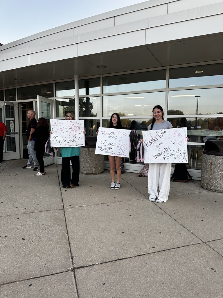 Students holding Powder Puff signs 