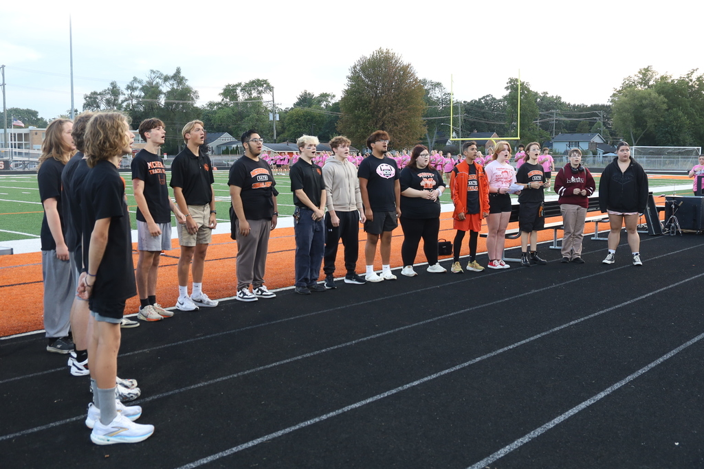 Choir singing on sideline