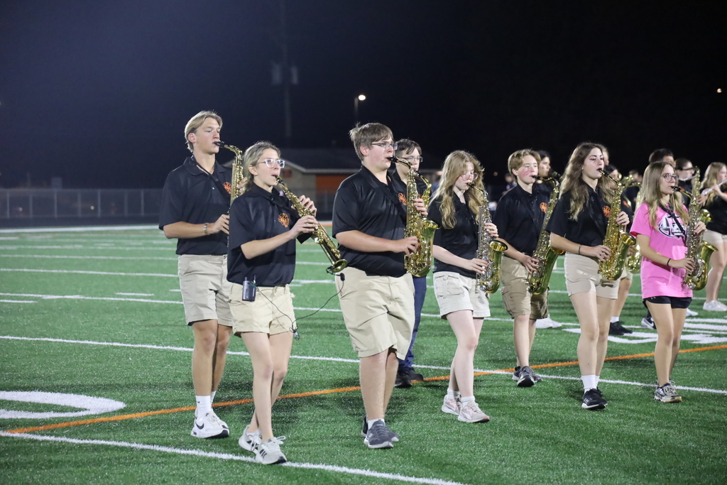Band saxophones performing on the field 