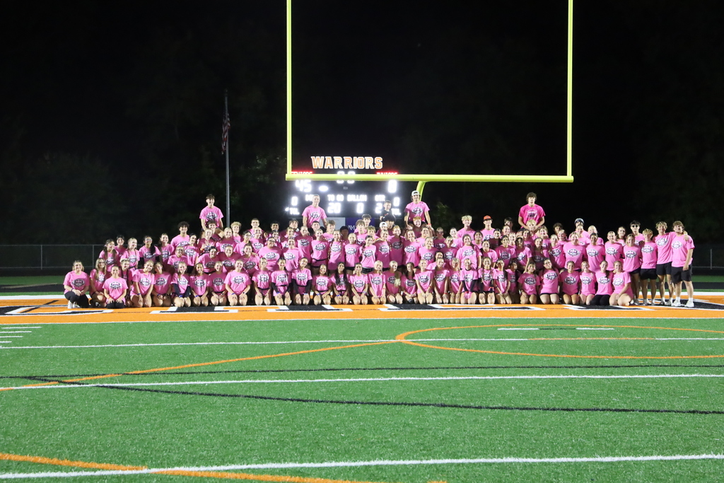 Group photo of senior team in front of goal post