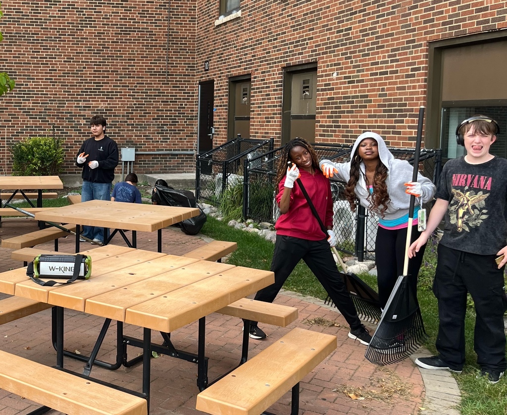 Students outside with rakes 