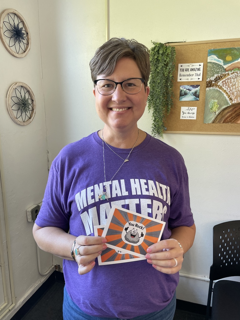 Erin Harris holding "You rock" card