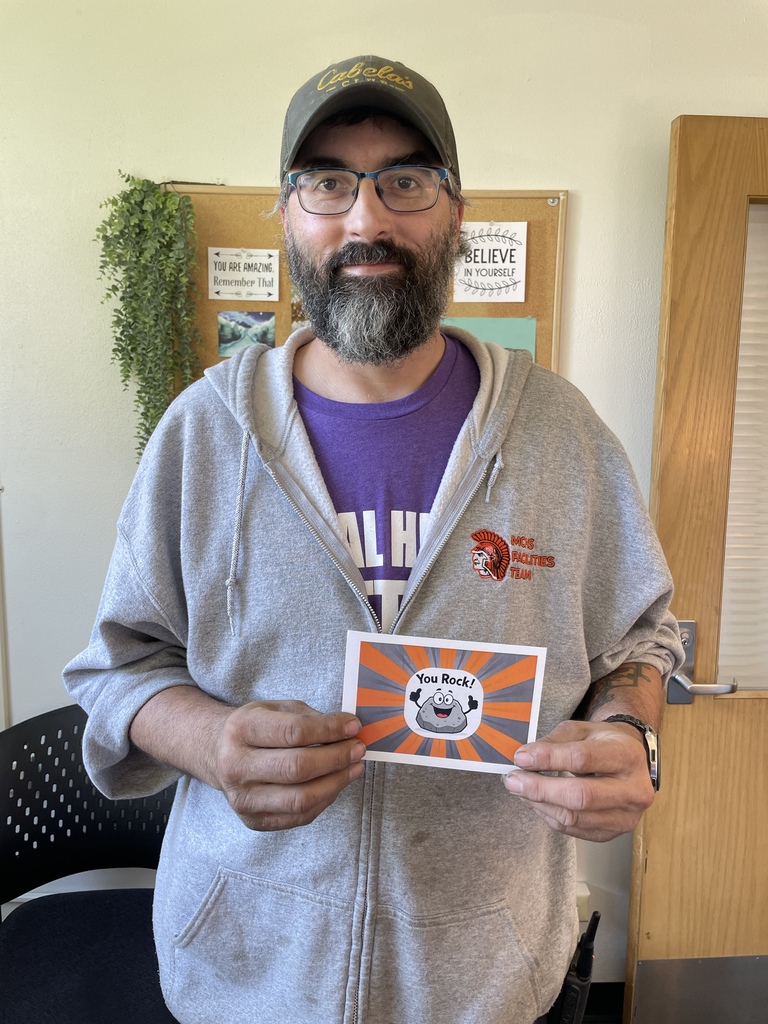 Ryan Sluga holding you rock card
