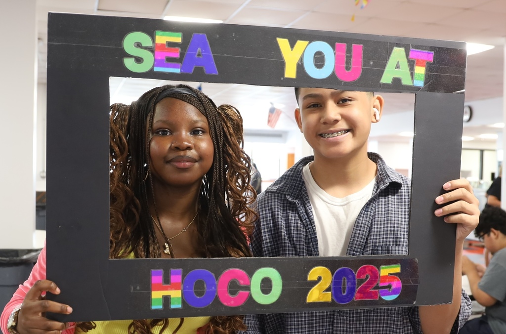 Two students in a photo frame that says "Sea You at HOCO 2025"